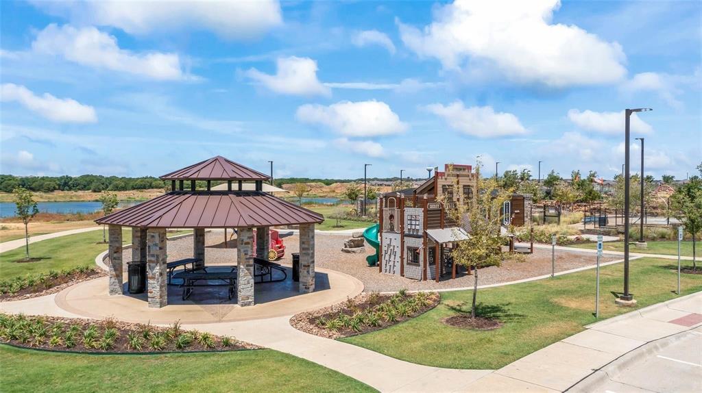 11105 Autry Ridge Lane Aubrey, TX 76227 - Photo 23 of 27 a view of a swimming pool with a sitting space