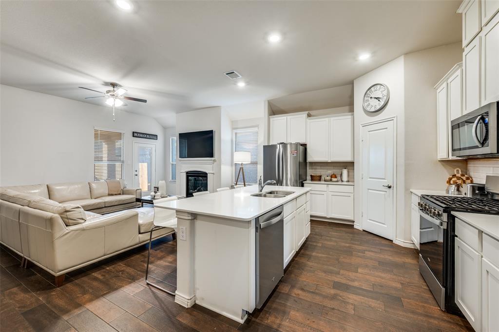 11105 Autry Ridge Lane Aubrey, TX 76227 - Photo 27 of 27 a open kitchen with cabinets a stove and a sink