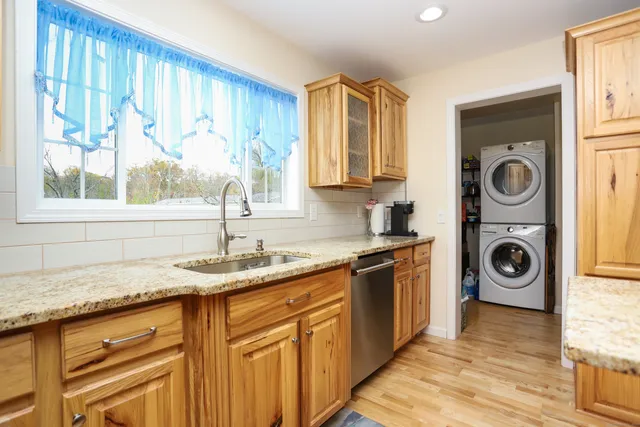 a kitchen with a sink cabinets and a wooden floor