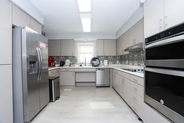 a kitchen with a refrigerator sink and microwave