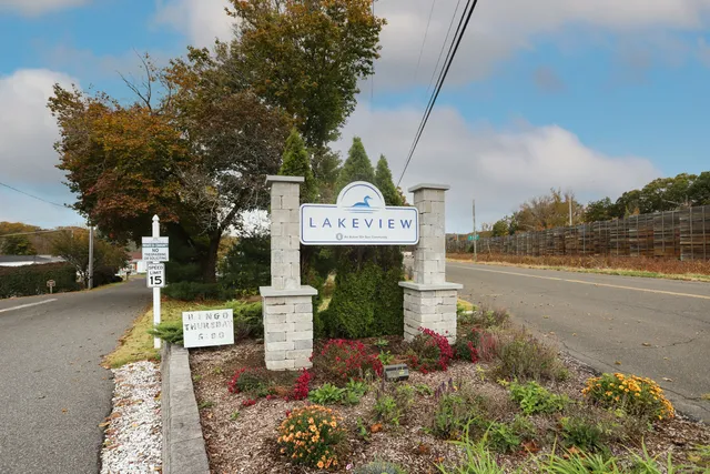 a front view of a house with a yard and fountain