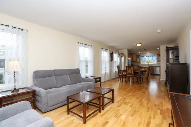 a living room with furniture and kitchen view