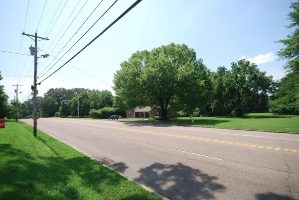 a view of a road with a big yard