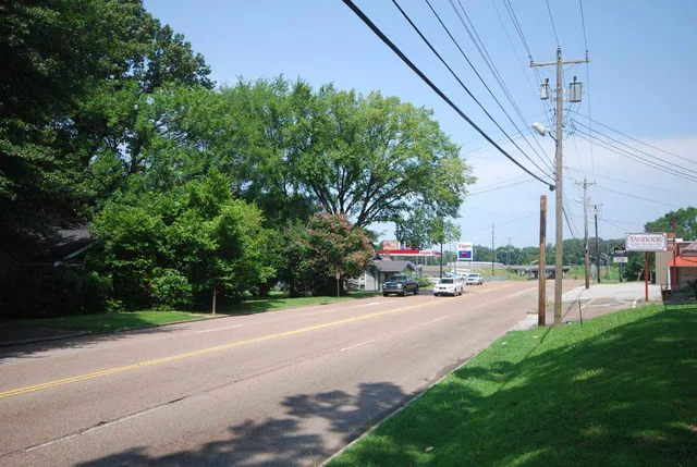 a view of a road with a bench in the background