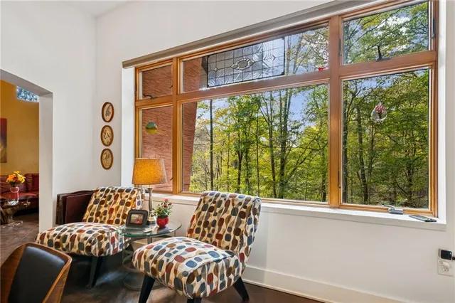 a bedroom with furniture and a large window