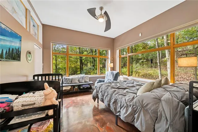 a spacious bedroom with a bed and a couch