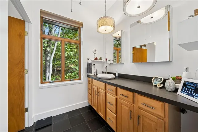 a kitchen with stainless steel appliances granite countertop a window and a sink