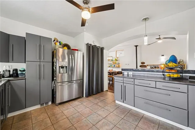a kitchen with stainless steel appliances granite countertop a refrigerator and a sink
