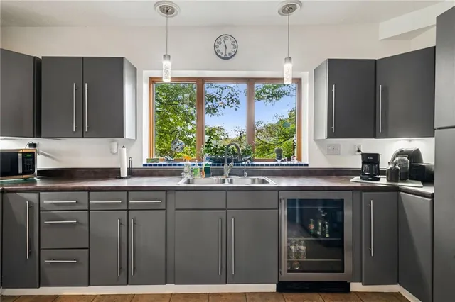 a kitchen with stainless steel appliances granite countertop a sink and a window