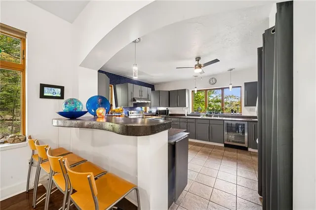 a kitchen with stainless steel appliances kitchen island granite countertop a sink and cabinets