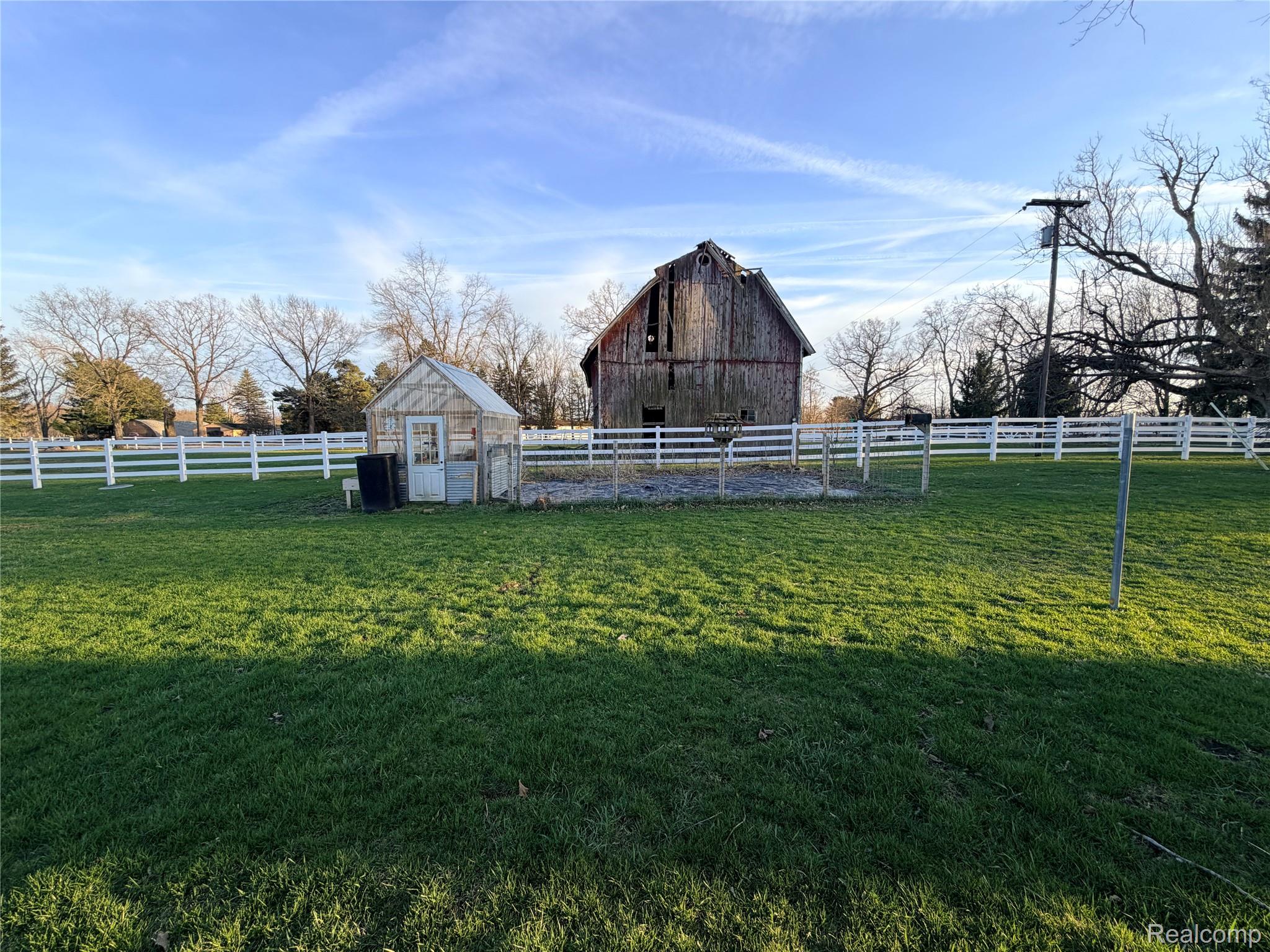 6038 Byron Road Howell, MI 48855 - Photo 8 of 24 View of yard featuring an outbuilding, a barn, and a rural view