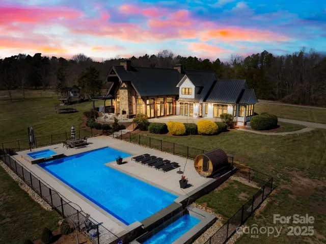 aerial view of a house with pool and chairs