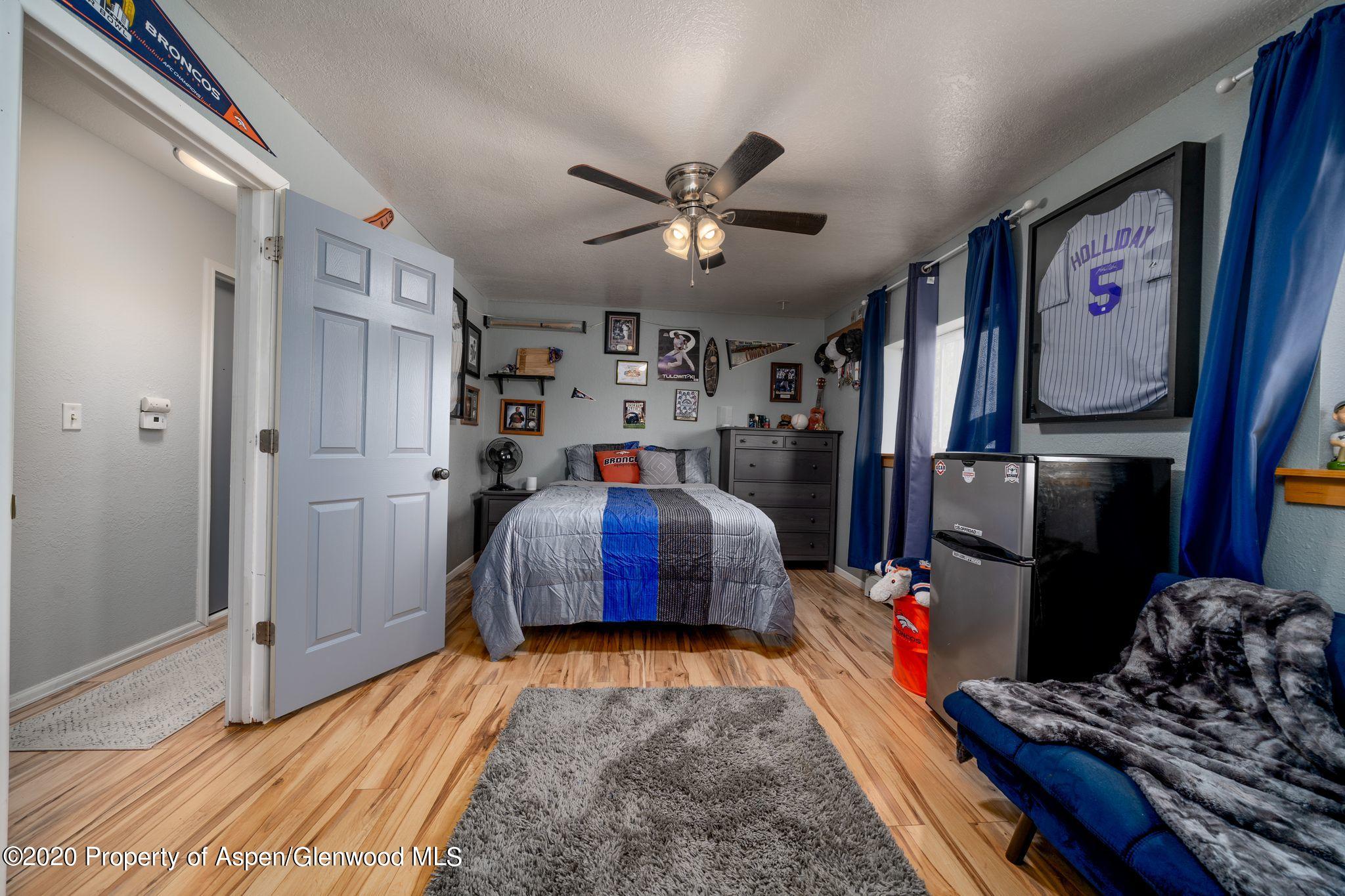 535 Aspen Avenue Rifle, CO 81650 - Photo 14 of 27 a bedroom with bed and wooden floor
