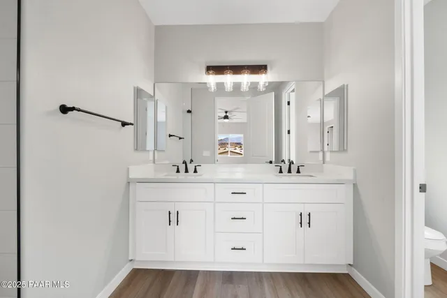 a bathroom with a double vanity sink and mirror