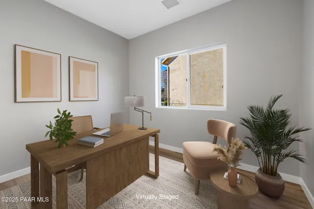 a dining room with furniture and potted plant