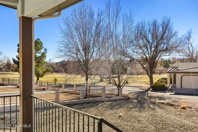a view of a backyard with wooden fence
