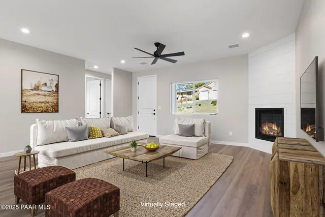a living room with furniture and a fireplace