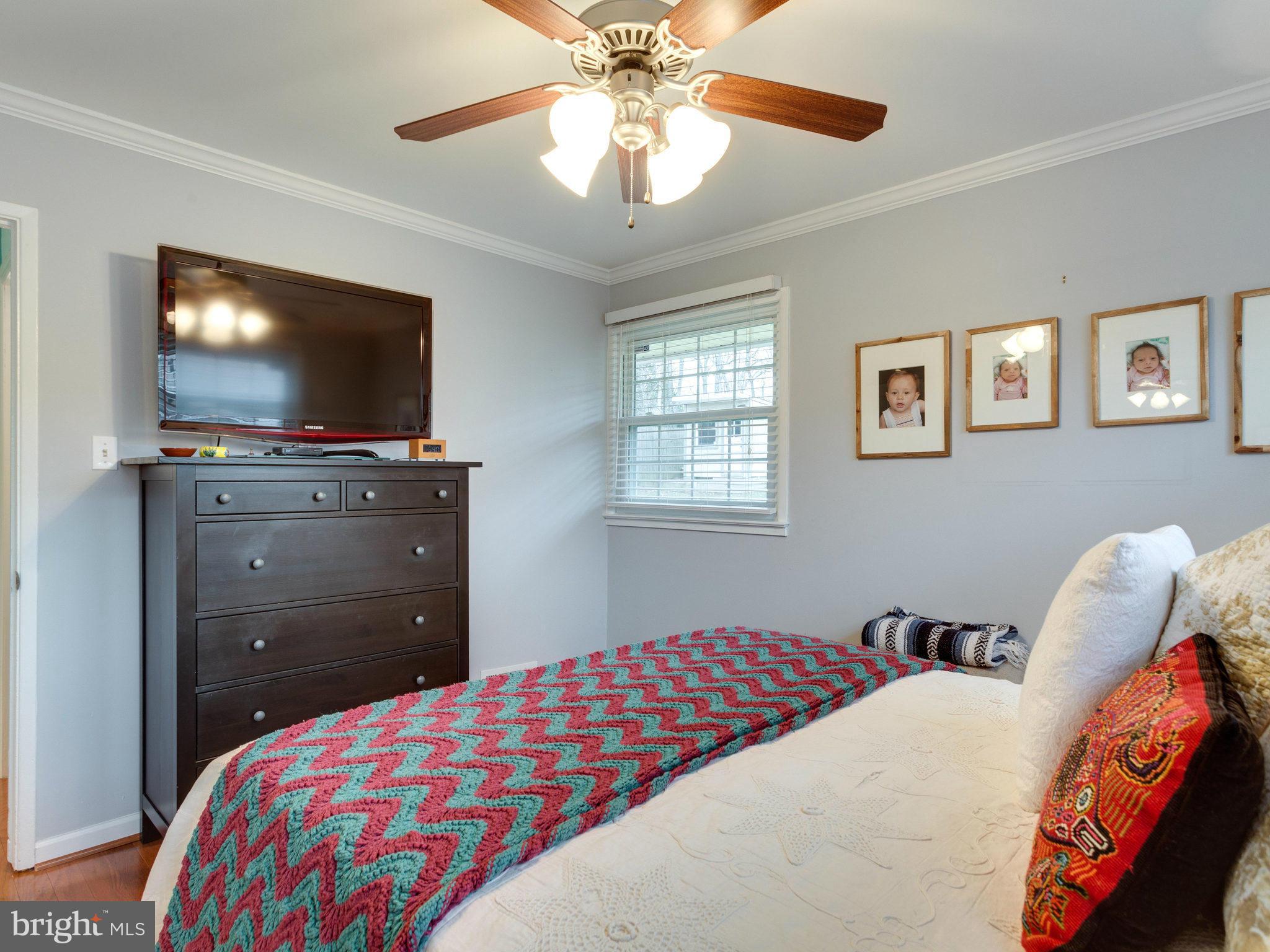 5303 Inverchapel Road Springfield, VA 22151 - Photo 16 of 18 a bedroom with a bed and a flat screen tv
