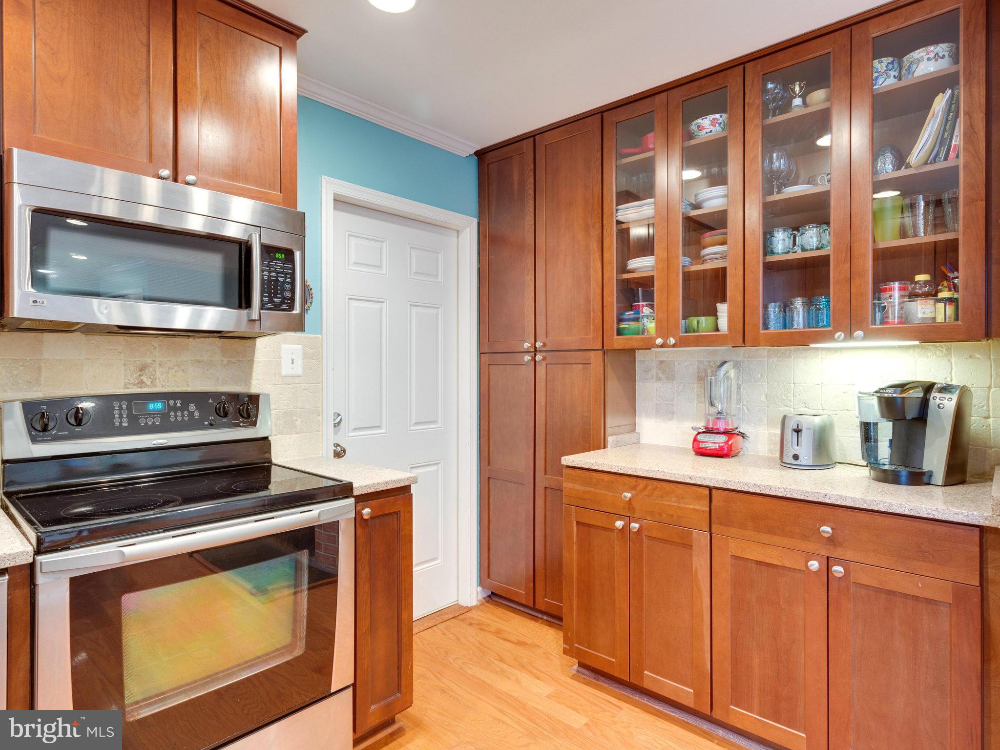 5303 Inverchapel Road Springfield, VA 22151 - Photo 8 of 18 a kitchen with stainless steel appliances granite countertop a stove and cabinets