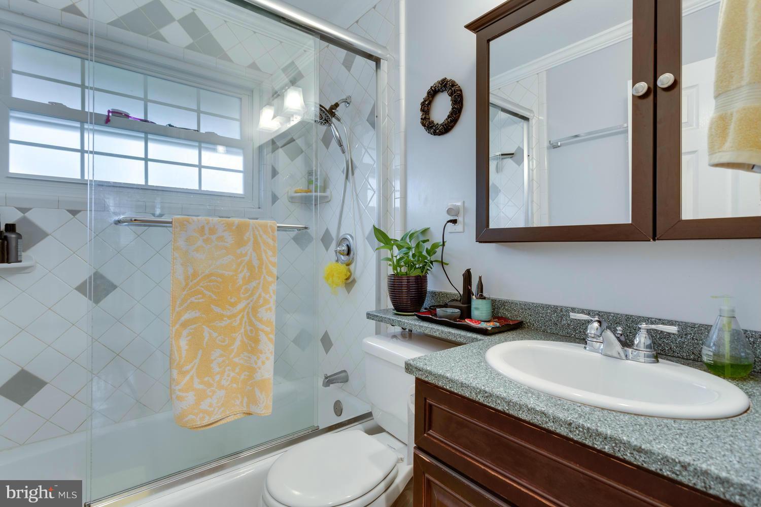 5303 Inverchapel Road Springfield, VA 22151 - Photo 10 of 18 a bathroom with a granite countertop sink and a mirror