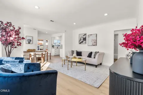 a living room with furniture and flowers