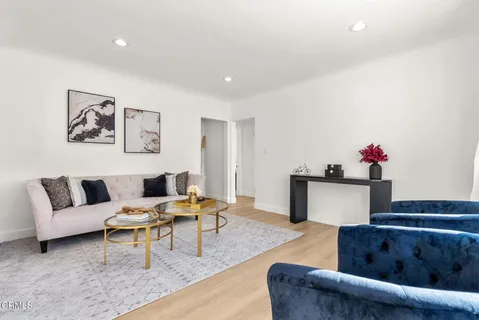a living room with furniture and flowers