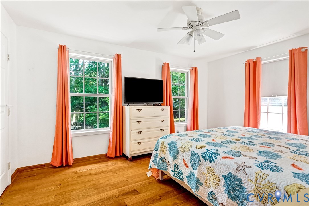 233 Washington Street Reedville, VA 22539 - Photo 15 of 35 Bright bedroom with multiple windows framed by ora
