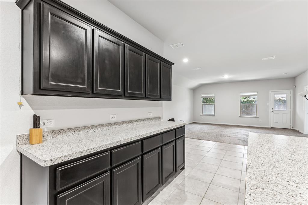 714 Wolf Creek Cleburne, TX 76033 - Photo 12 of 40 a kitchen with a sink and cabinets