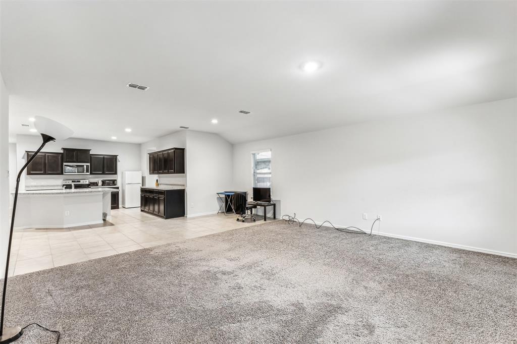 714 Wolf Creek Cleburne, TX 76033 - Photo 21 of 40 a view of a kitchen with microwave and cabinets