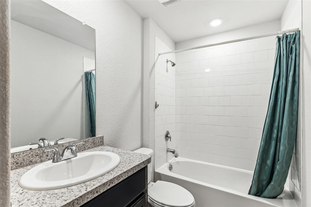 714 Wolf Creek Cleburne, TX 76033 - Photo 26 of 40 a bathroom with a granite countertop sink toilet and shower