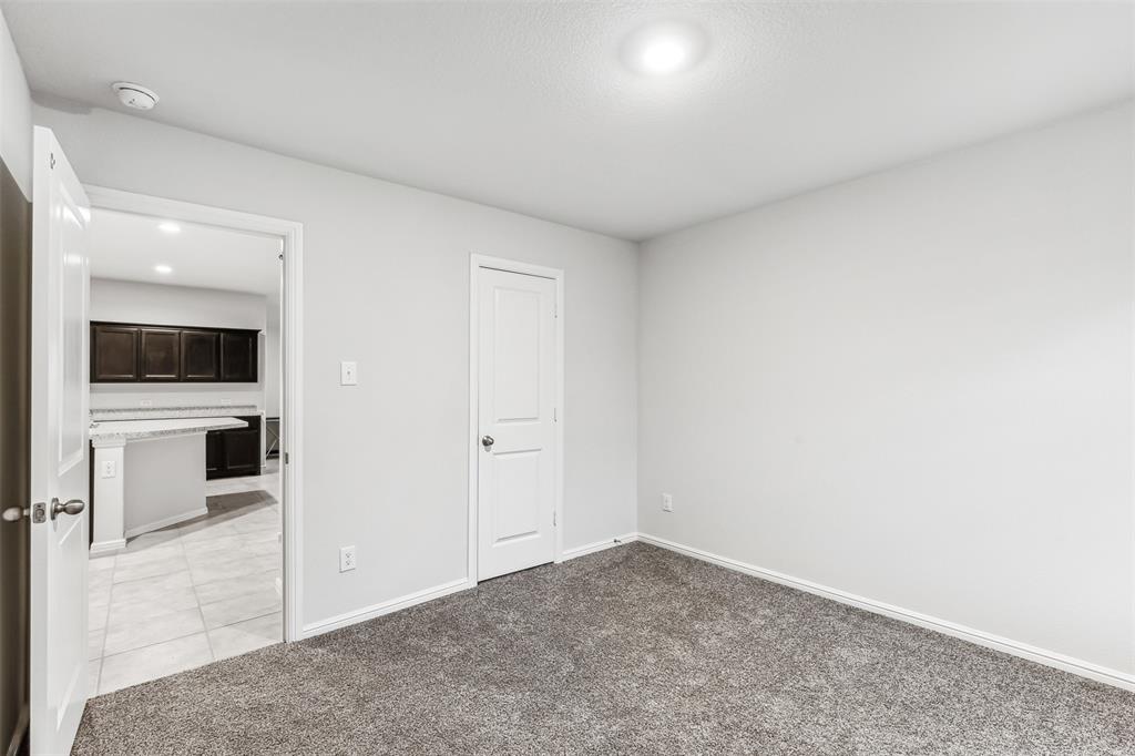 714 Wolf Creek Cleburne, TX 76033 - Photo 28 of 40 an empty room with a kitchen