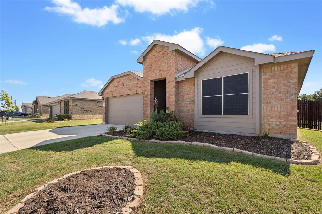 714 Wolf Creek Cleburne, TX 76033 - Photo 3 of 40 a front view of a house with a yard