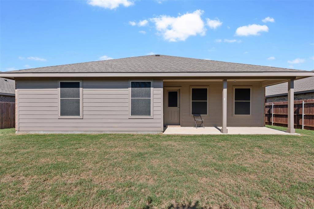 714 Wolf Creek Cleburne, TX 76033 - Photo 38 of 40 a front view of a house with a yard and garage