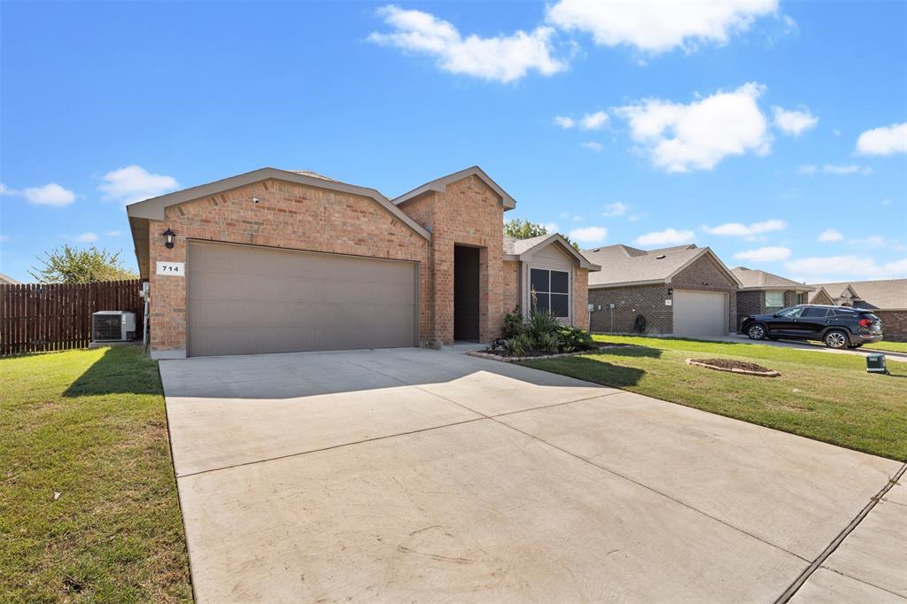 714 Wolf Creek Cleburne, TX 76033 - Photo 4 of 40 a view of a house with a yard and garage