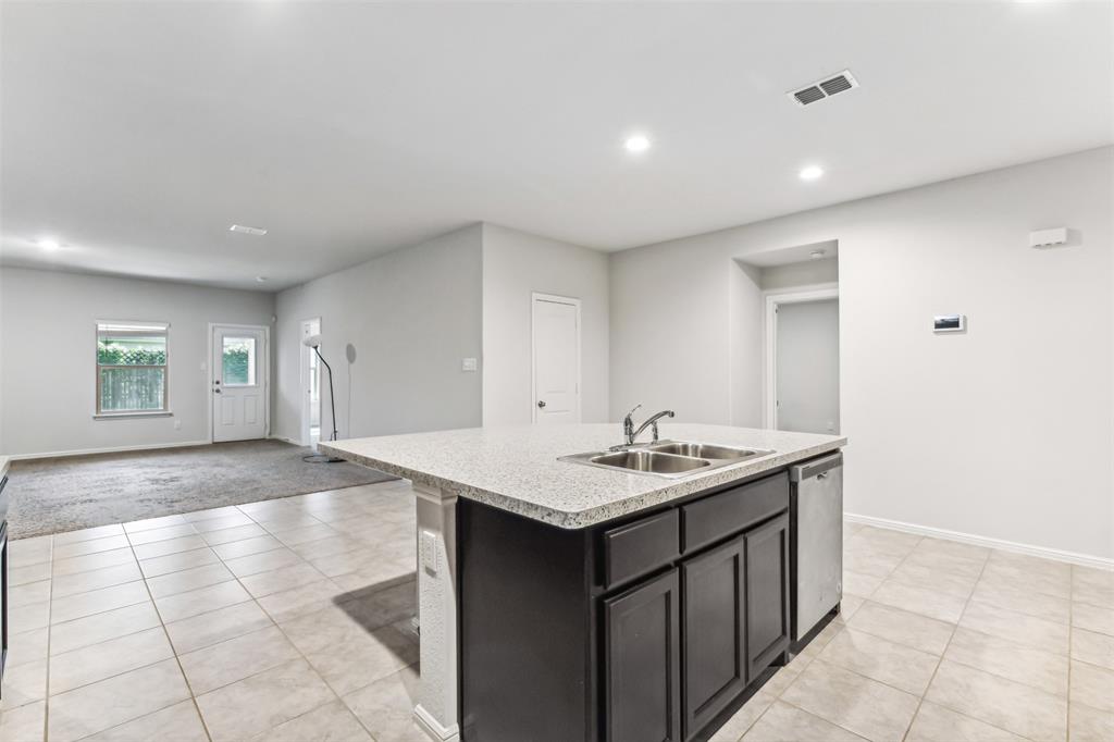 714 Wolf Creek Cleburne, TX 76033 - Photo 8 of 40 a kitchen with a sink a stove and cabinets