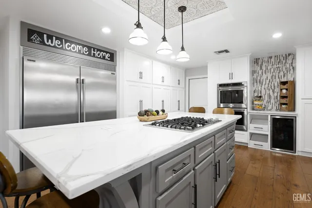 a kitchen with a stove a refrigerator and a fireplace