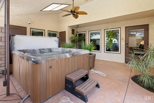 a potted plant sitting on top of a wooden bench in a back yard