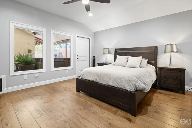 a bedroom with a bed and a flat tv screen on a dresser