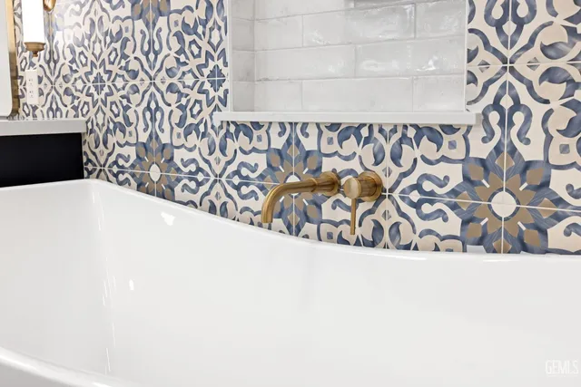 a bathroom with a bathtub a sink and a mirror