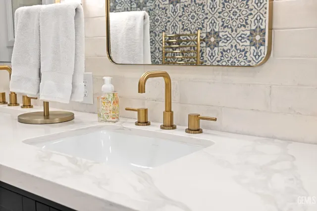 a bathroom with a double vanity sink a mirror and a toilet