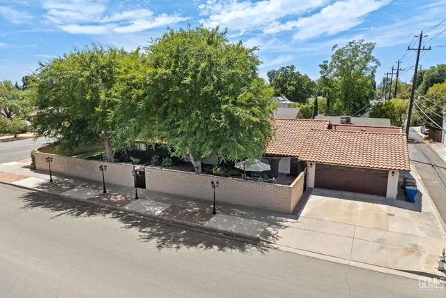 a view of a patio with couches and table and chairs with wooden fence