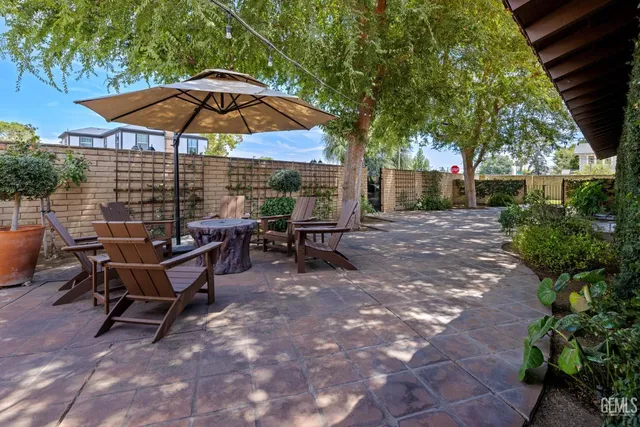 a view of a backyard with a patio and outdoor seating