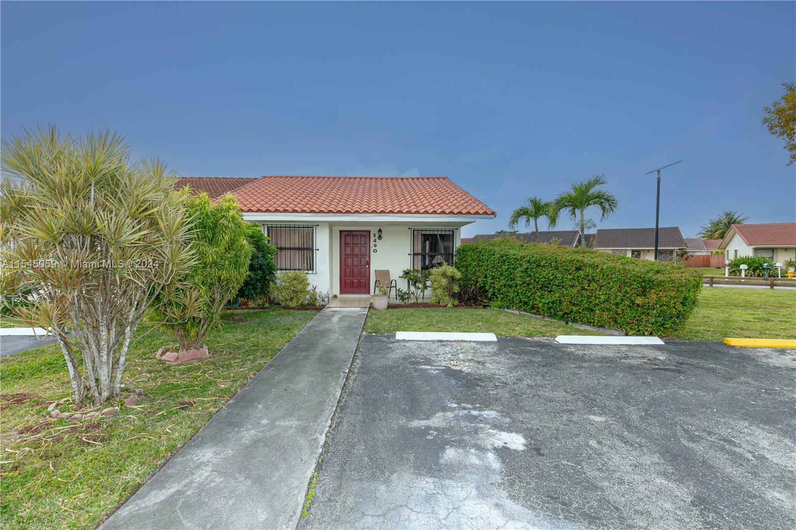 1490 Southwest 124th Pl Concourse Miami, FL 33184 - Photo 1 of 16 a view of a house with a yard