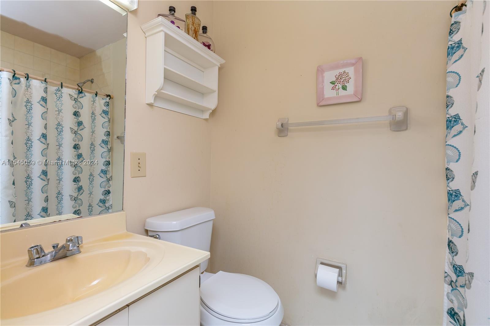 1490 Southwest 124th Pl Concourse Miami, FL 33184 - Photo 11 of 16 a white toilet sitting next to a bathroom sink