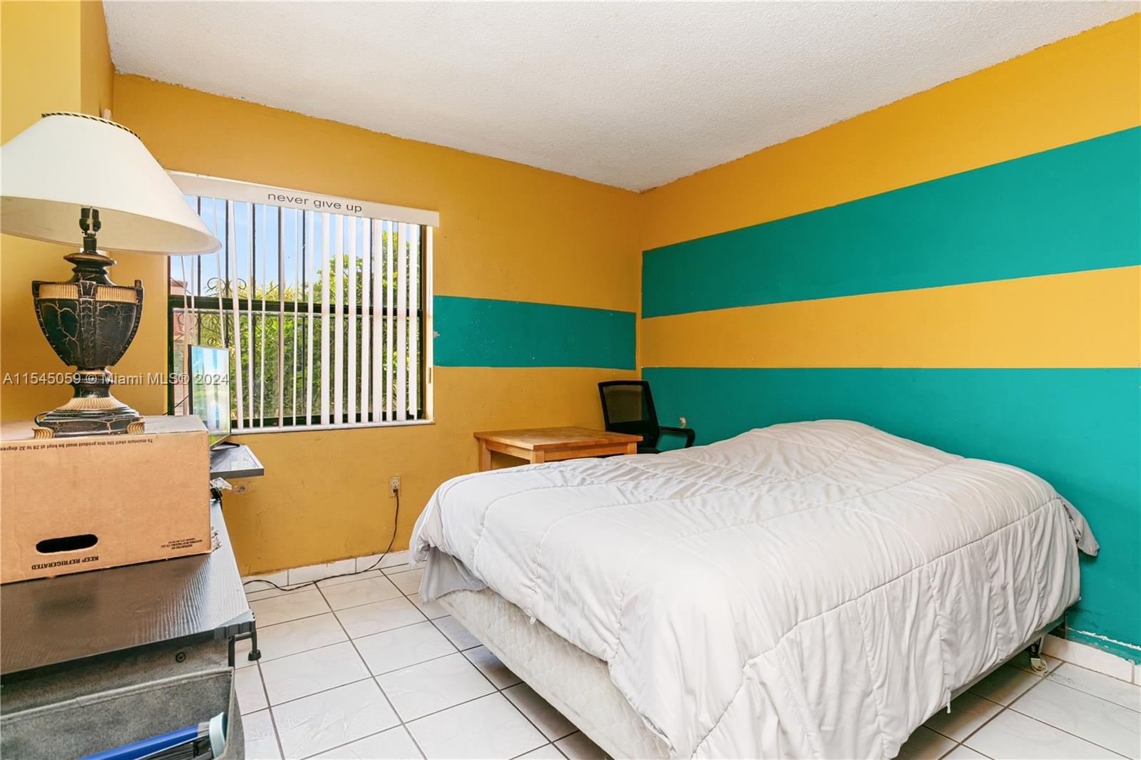 1490 Southwest 124th Pl Concourse Miami, FL 33184 - Photo 12 of 16 a bedroom with a bed and a chair