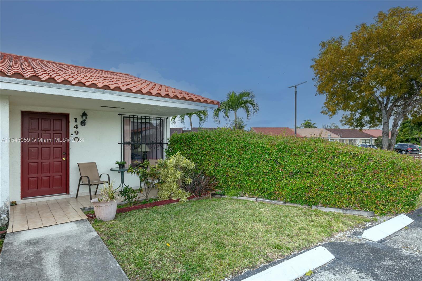 1490 Southwest 124th Pl Concourse Miami, FL 33184 - Photo 2 of 16 a front view of a house with garden