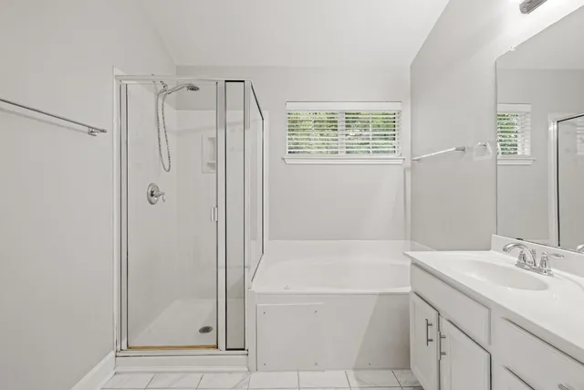 a kitchen with granite countertop white cabinets and stainless steel appliances