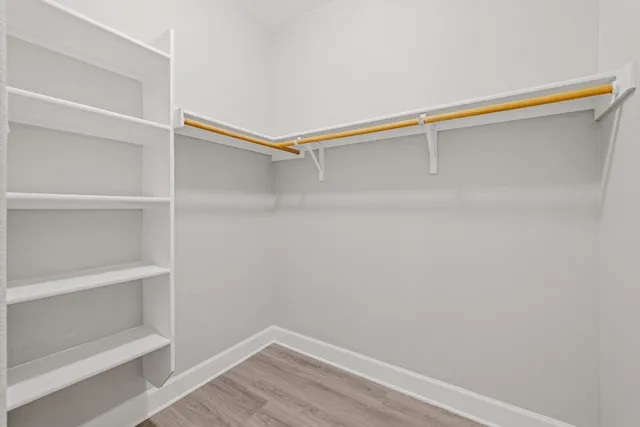 a kitchen with stainless steel appliances granite countertop a stove and wooden floor