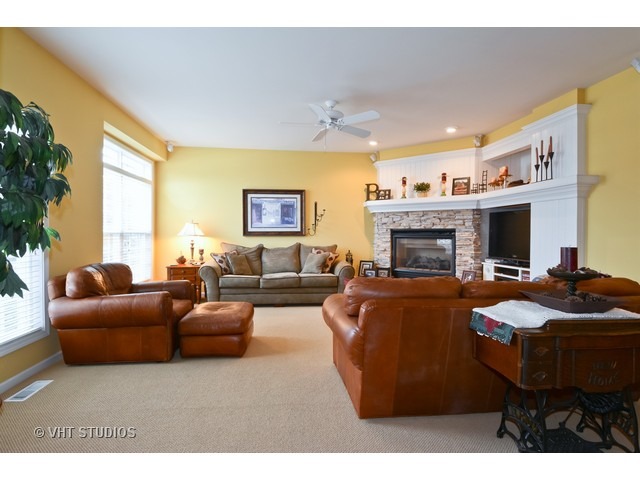 756 Ridge Drive Elburn, IL 60119 - Photo 2 of 18 a living room with furniture a fireplace and a large window