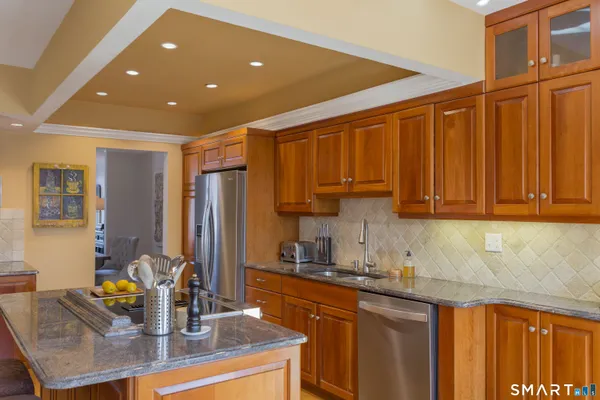 a kitchen with kitchen island granite countertop a sink and cabinets